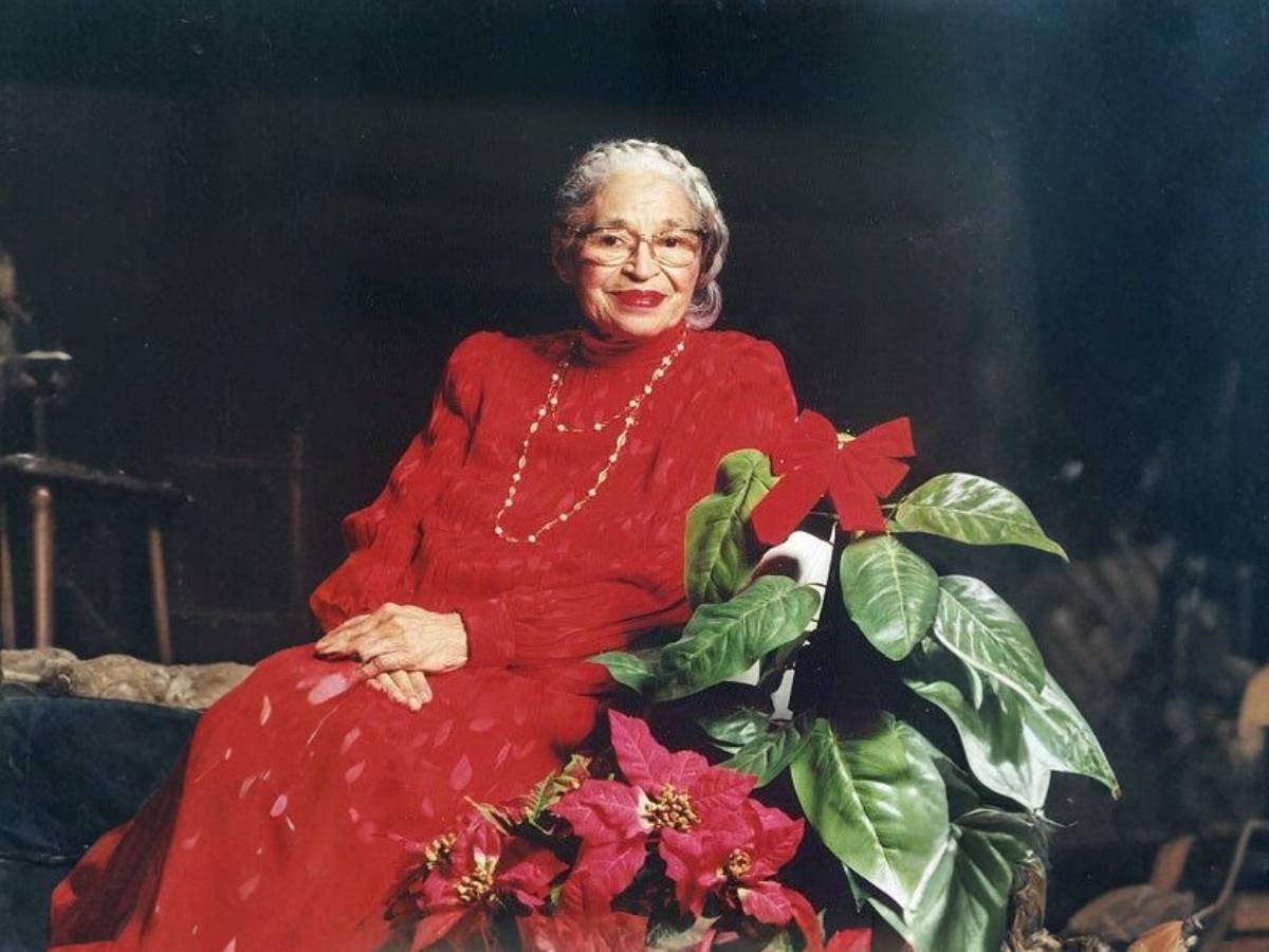 Rosa Parks sitting on a chair, reflecting her calm determination and strength during the Civil Rights Movement.