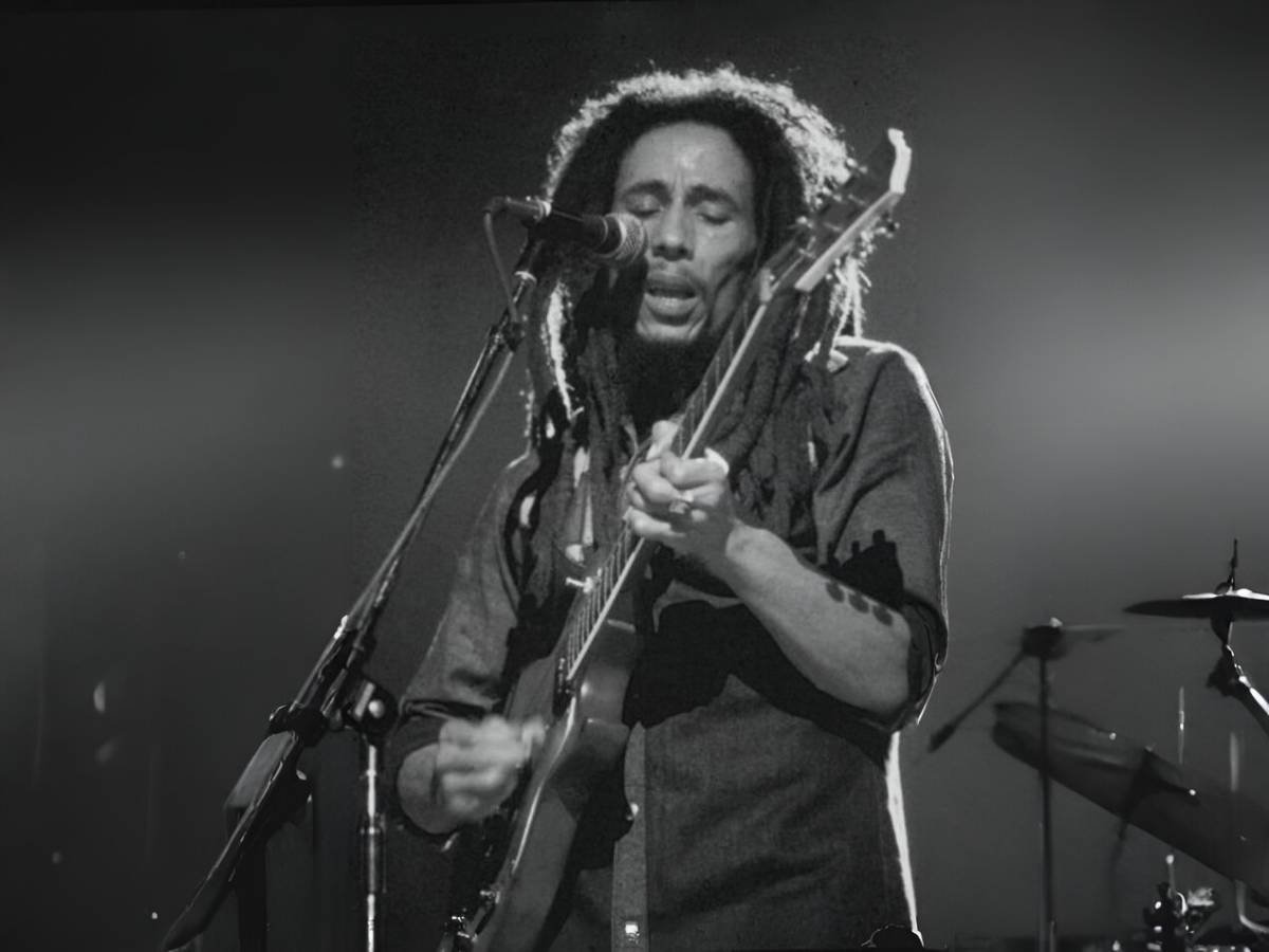 Bob Marley performing on stage, embodying the spirit of reggae music.